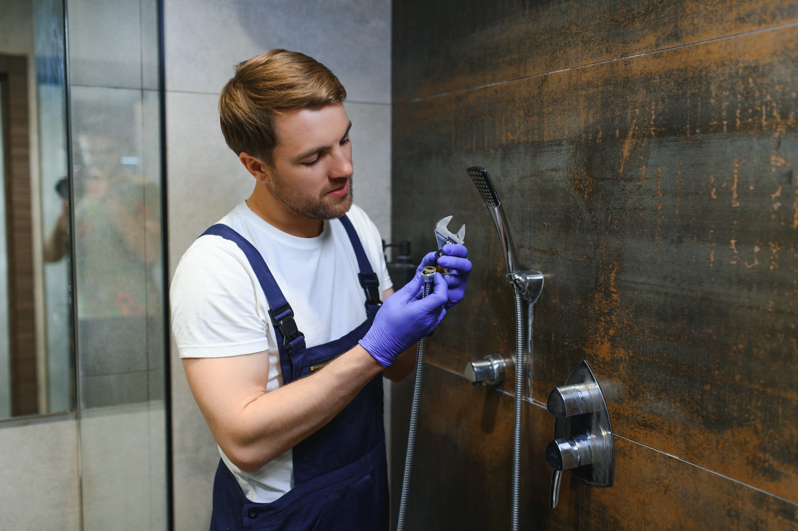 professional handyman working shower booth indoors scaled